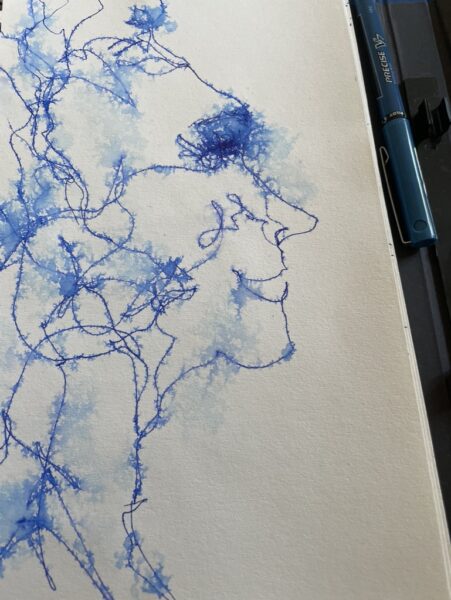 blue ink pen scribble drawing of a face in the tree branches