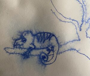 blue ink drawing of a lizard on a branch