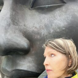 Mother’s Day Again- in France Lori's face next to a large face sculpture in Angers